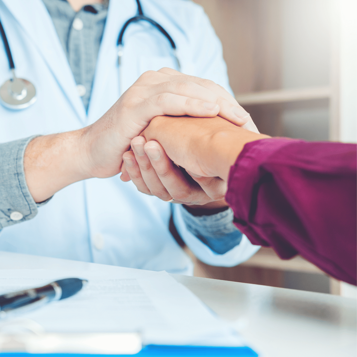 Doctor holding patients hand